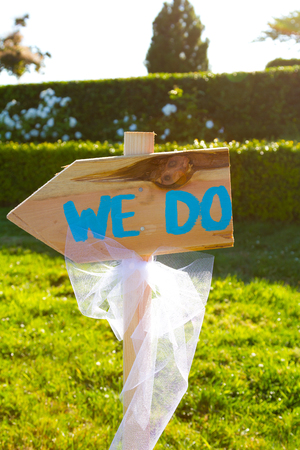 Wedding ceremony sign points to the left and says we do.の写真素材