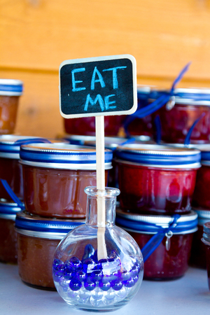 Sign says eat me in front of some homemade canned jam at a wedding reception.の写真素材