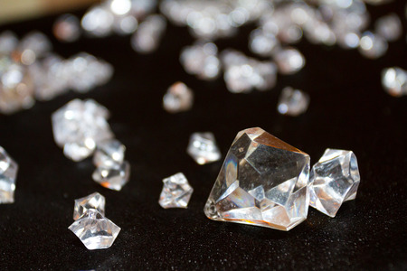 Crystals and diamonds together on black velvet.