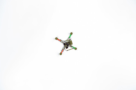 DALLAS, OR - JUNE 28, 2014: Phantom quad copter drone with Go Pro hero 3 camera connected flying...