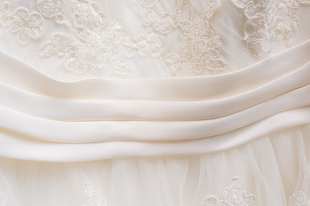 White wedding dress hanging outside before a ceremony.の写真素材