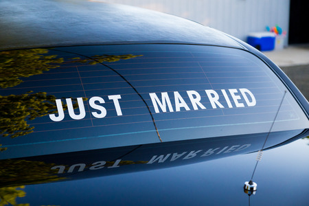 Just married sign on the back of a traditional black limo at a wedding.の写真素材