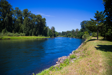 Springfield Oregon's McKenzie River flows on the edge of town slowly with ample opportunity for intertubing recreation.の写真素材