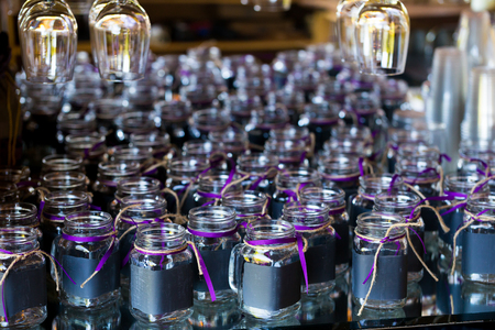 DIY wedding reception drinks in mason jars painted with chalkboard paint for the guests to be able to write their names.の写真素材