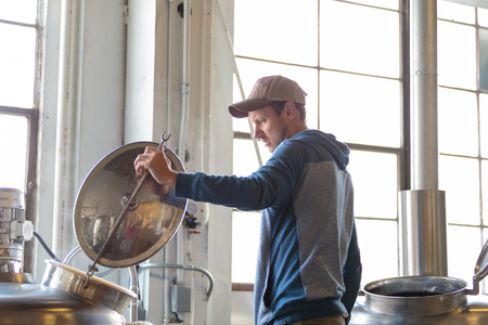 EUGENE, OR - NOVEMBER 4, 2015: Brewery owner Wes Gunderson brewing an IPA at the startup craft brewery Mancave Brewing.のeditorial素材