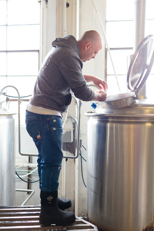 EUGENE, OR - NOVEMBER 4, 2015: Head brewmaster Brandon Woodruff commercially brewing an IPA at the startup craft brewery Mancave Brewing.のeditorial素材