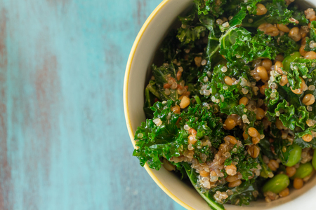 Superfood salad with raw kale, quinoa, blueberries, and barley is perfect for the paleo diet for weight loss.