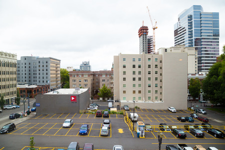 PORTLAND, OR - AUGUST 30, 2014: Downtown Portland Oregon with a parking lot and tall buildings, looking North from the Portland Art Museum midday.のeditorial素材