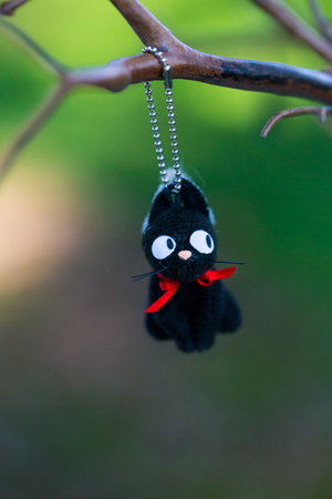 Animal ornament hanging from a sparse tree branch at a wedding reception.