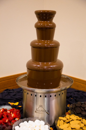 EUGENE, OR - SEPTEMBER 13, 2014: Sephra chocolate fondu tower at a wedding reception with items to dip into this sweet dessert.のeditorial素材