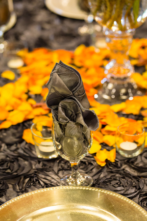 Napkin stuffed into a wine glass at a wedding reception.の写真素材