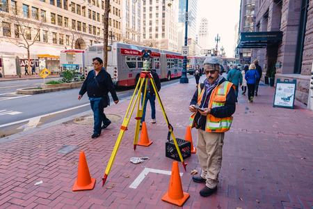 SAN FRANCISCO, CA - DECEMBER 11, 2015: Survey worker near a construction site in downtown San Francisco.のeditorial素材