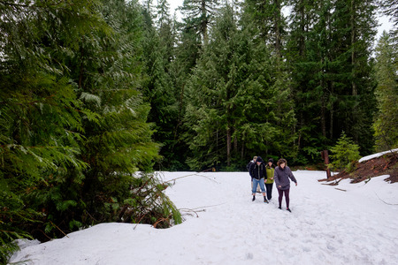 MCKENZIE BRIDGE, OR - MARCH 5, 2016: Family snow hike to Koosah Falls on the McKenzie River in Oregon.のeditorial素材