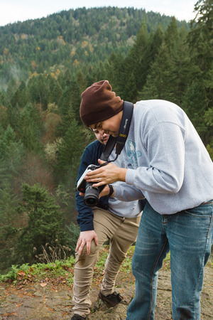 SPRINGFIELD, OR - NOVEMBER 17, 2016: Videographer creating movie clips in nature with a 4K cinema camera outdoors.のeditorial素材