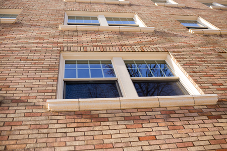 Windows on a brick apartment building that is also home to some condo houses in downtown Portland...