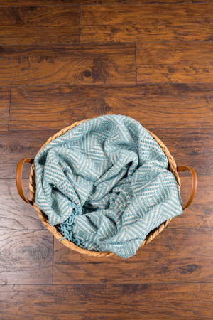 Basket with a blanket inside awaiting a newborn baby during a studio photo session by a professional photographer.の写真素材