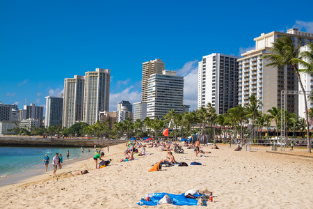 HONOLULU, OAHU, HAWAII - FEBRUARY 22, 2017: Waikiki Beach and the city of Honolulu on Oahu Hawaii with tourists and locals on the beach and in the water of the Pacific Ocean.のeditorial素材