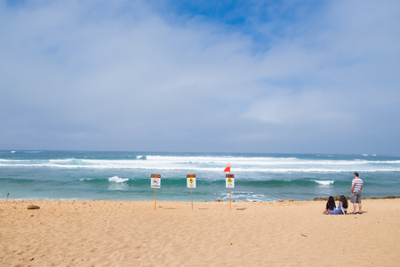 HALEIWA, OAHU, HAWAII - FEBRUARY 15, 2017: High surf warnings and a strong riptide prompt lifeguards to put up a red flag warning sign and no swimming at Haleiwa Beach Park in Oahu Hawaii.のeditorial素材