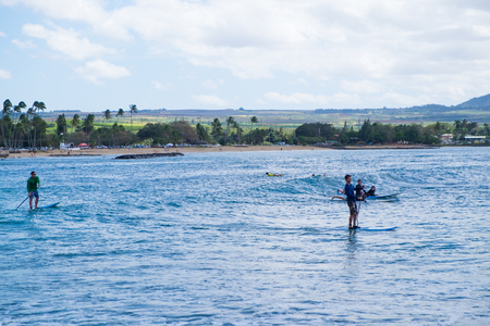 HALE'IWA, OAHU, HAWAII - FEBRUARY 23, 2017: Very busy day with many surfers and surf schools in the water catching waves in Haleiwa Oahu Hawaii.のeditorial素材