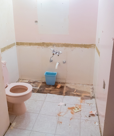 Bathroom with a pink toilette during demo day on a residential home renovation and major remodel.の写真素材