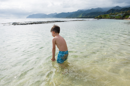 Child Playing on Beach in Oahu Hawaiiの写真素材