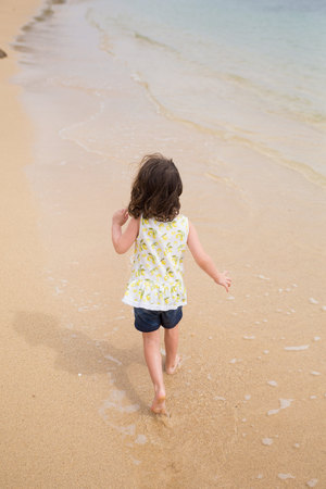 Child Playing on Beach in Oahu Hawaiiの写真素材