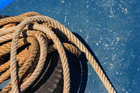 Close-up the old frayed boat rope on blue texture background.の写真素材