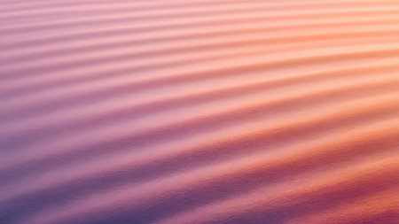 gentle water ripples create a calming abstract background with a soft pink and orange gradient textureの素材