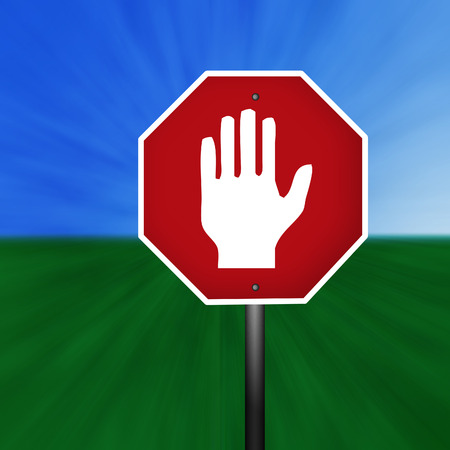 A stop sign with warning hand illustration with a grass and sky background.の写真素材