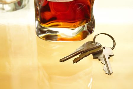 Glass of alcohol and key houseの写真素材