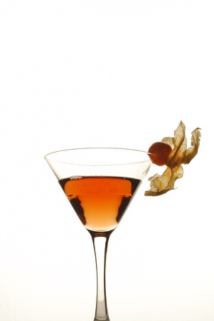 This is a martini glass with a witer cherry as decoration on a white background.の写真素材