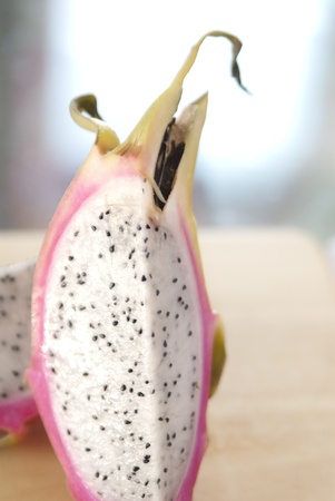 This is a cutted dragon fruit on a cutting board.の写真素材