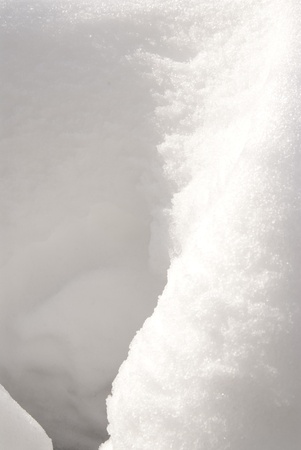 This is a close-up of a snow bank under the sun.の写真素材