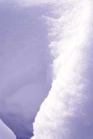 This is a close-up of a snow bank under the sun.の写真素材