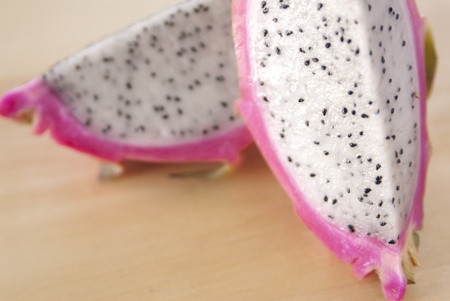 A cutted dragon fruit on a cutting board.の写真素材