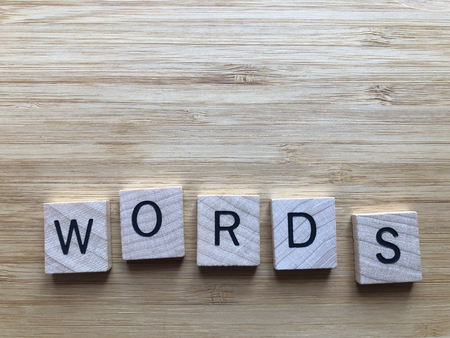 Words written in wooden alphabet letters isolated on a bamboo backgroundの写真素材