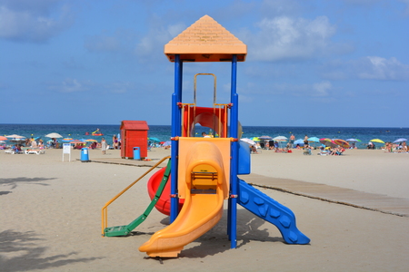 Colourful slides and play area, Arenal beach on the Costa Blanca in the summer, Javea, Alicante Province, Spainのeditorial素材
