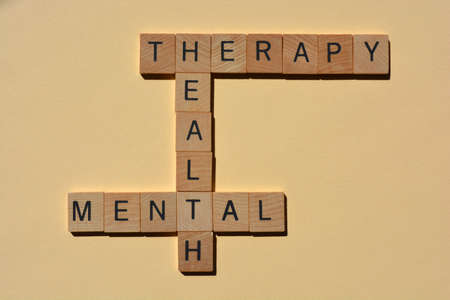Mental, Health, Therapy, words in wooden alphabet letters in crossword for isolated on plain backgroundの写真素材