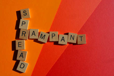 Rampant Spread, words in wooden alphabet letters in crossword form on colourful backgroundの写真素材