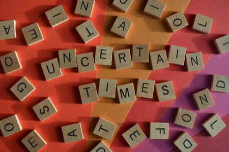 Uncertain Times, words surrounded by random alphabet lettersの写真素材