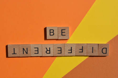 Be Different, words in wood alphabet letters isolated on backgroundの写真素材