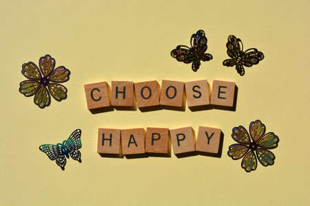 Choose Happy, words in wooden alphabet letters surrounded by flower and butterfly shapesの写真素材