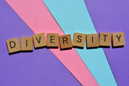 Diversity, word in wooden alphabet letters isolated on blue, pink and purple backgroundの写真素材