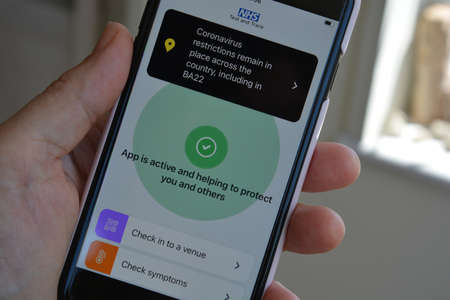 Yeovil, Somerset, England, July 18 2021: Smartphone with NHS Test and Trace app open, showing...