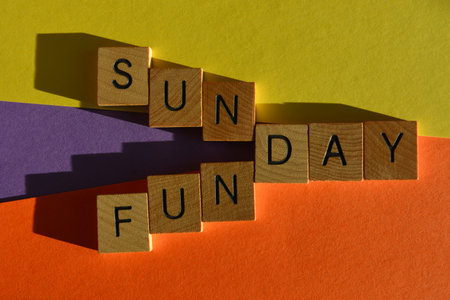 Sunday, Funday, words in wooden alphabet letters isolated on bright and colourful backgroundの写真素材