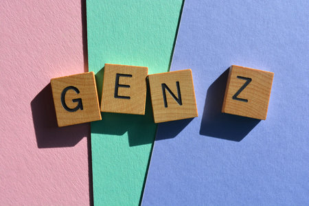 Gen Z, abbreviation for Generation Z the generational cohort following millennials in wooden alphabet letters isolated on colourful backgroundの写真素材