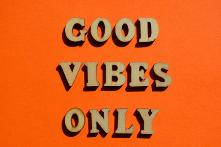 Good Vibes Only, words in wooden alphabet letters isolated on bright orange backgroundの写真素材