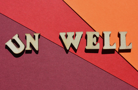Well, Unwell, words in wooden alphabet letters isolated on background as banner headline