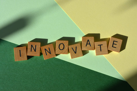 Innovate, word in wooden alphabet letters isolated on backgroundの写真素材