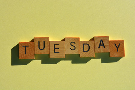 Tuesday, word in wooden alphabet letters isolated on backgroundの写真素材